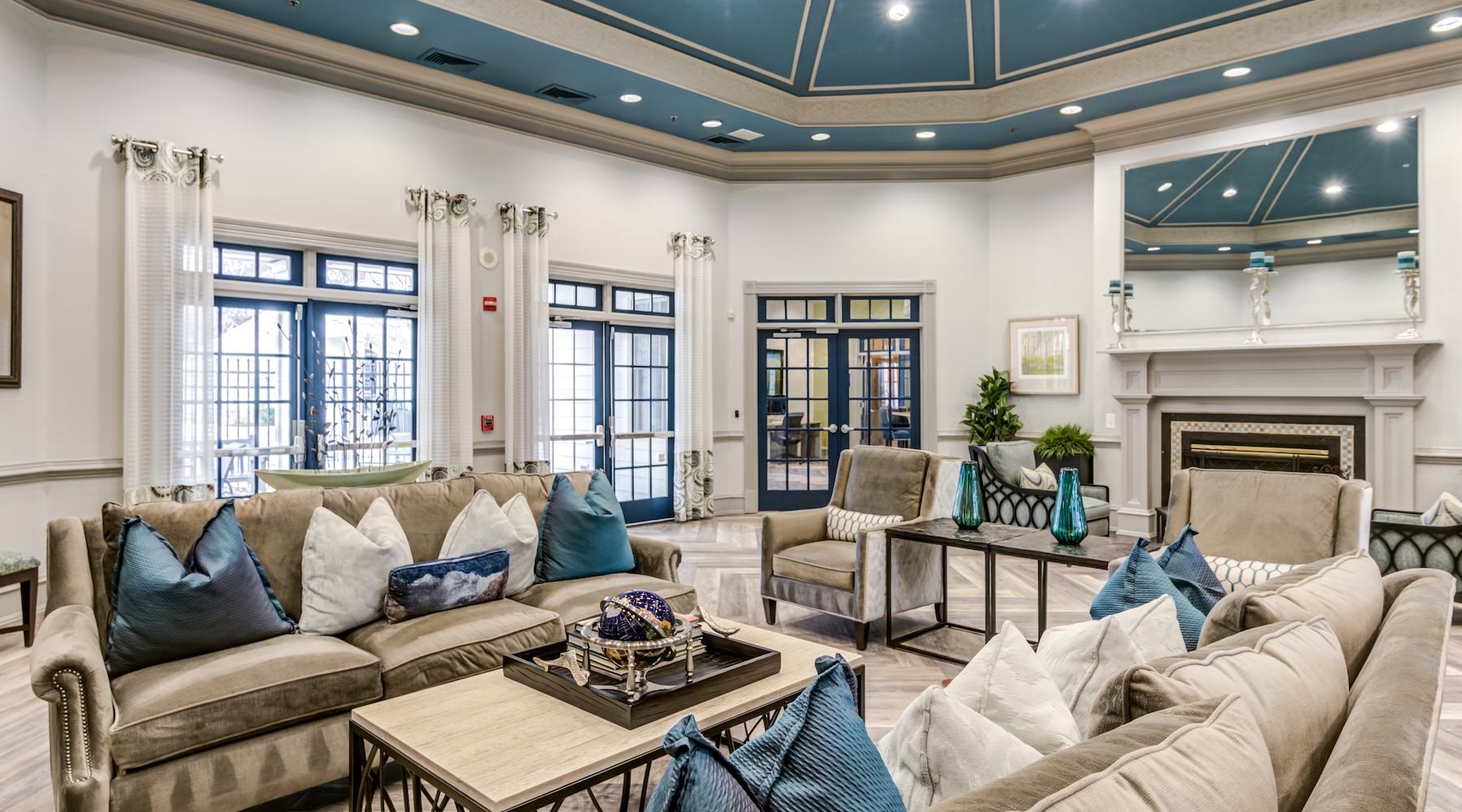 a clubroom with tables, chairs and couches