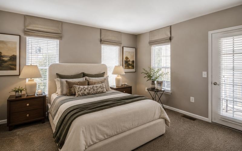a bedroom with a bed and lamps