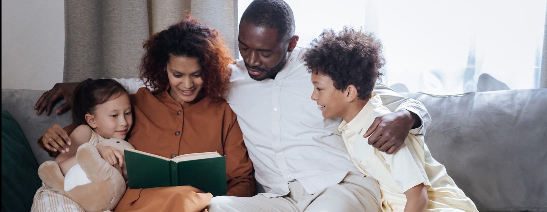 a family sitting on a couch